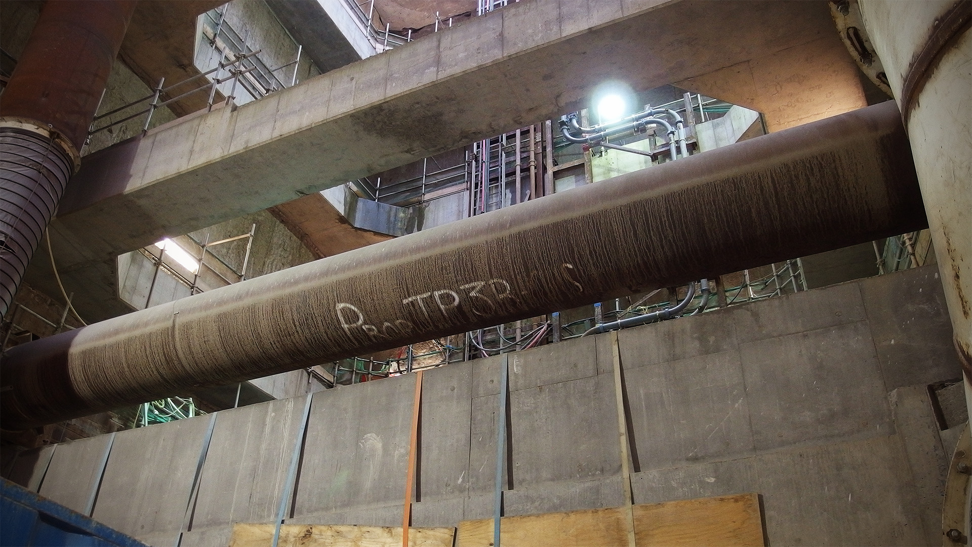 A massive steel prop supporting the walls of a deep shaft