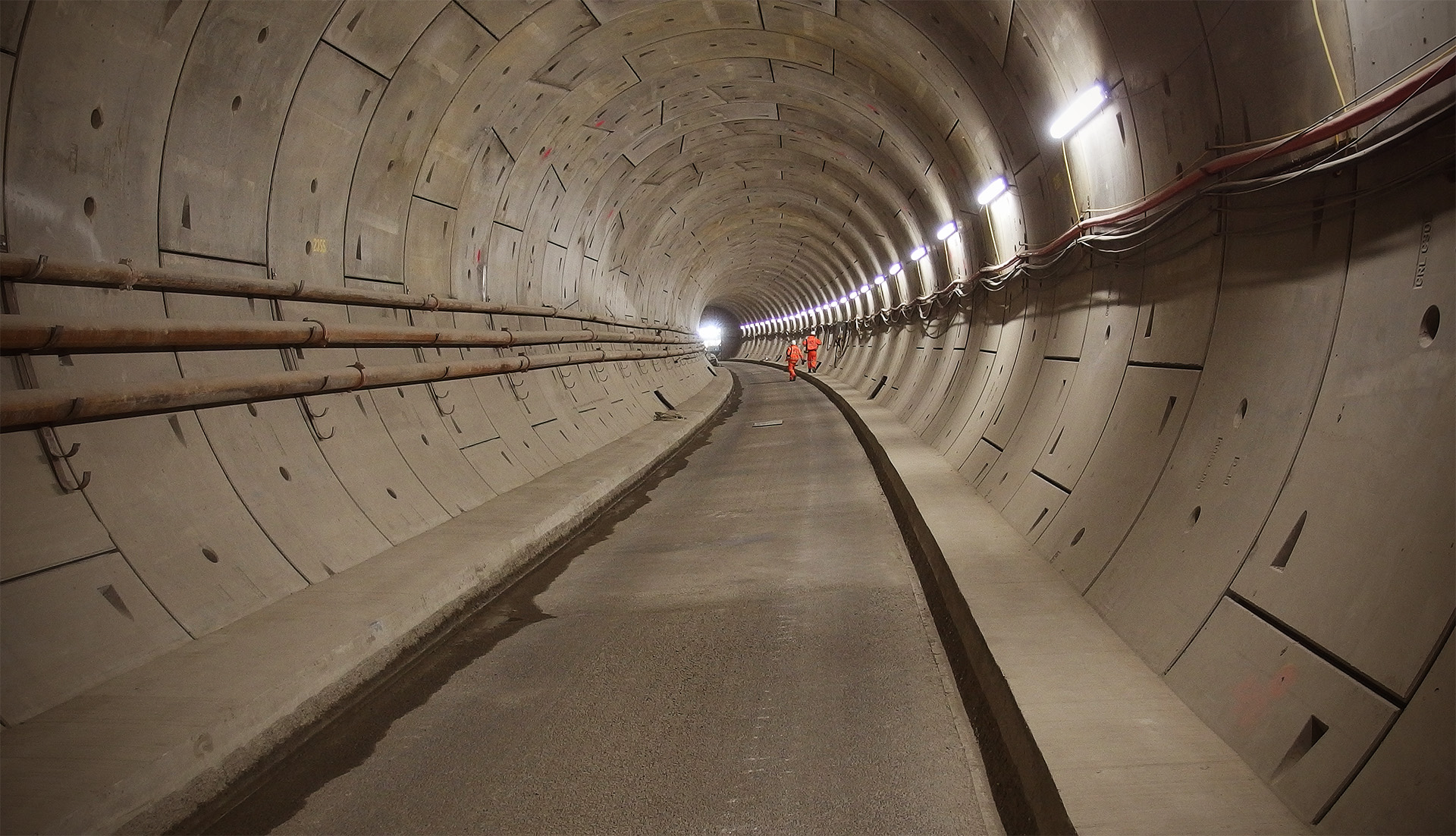A very curved tunnel stretches off into the distance