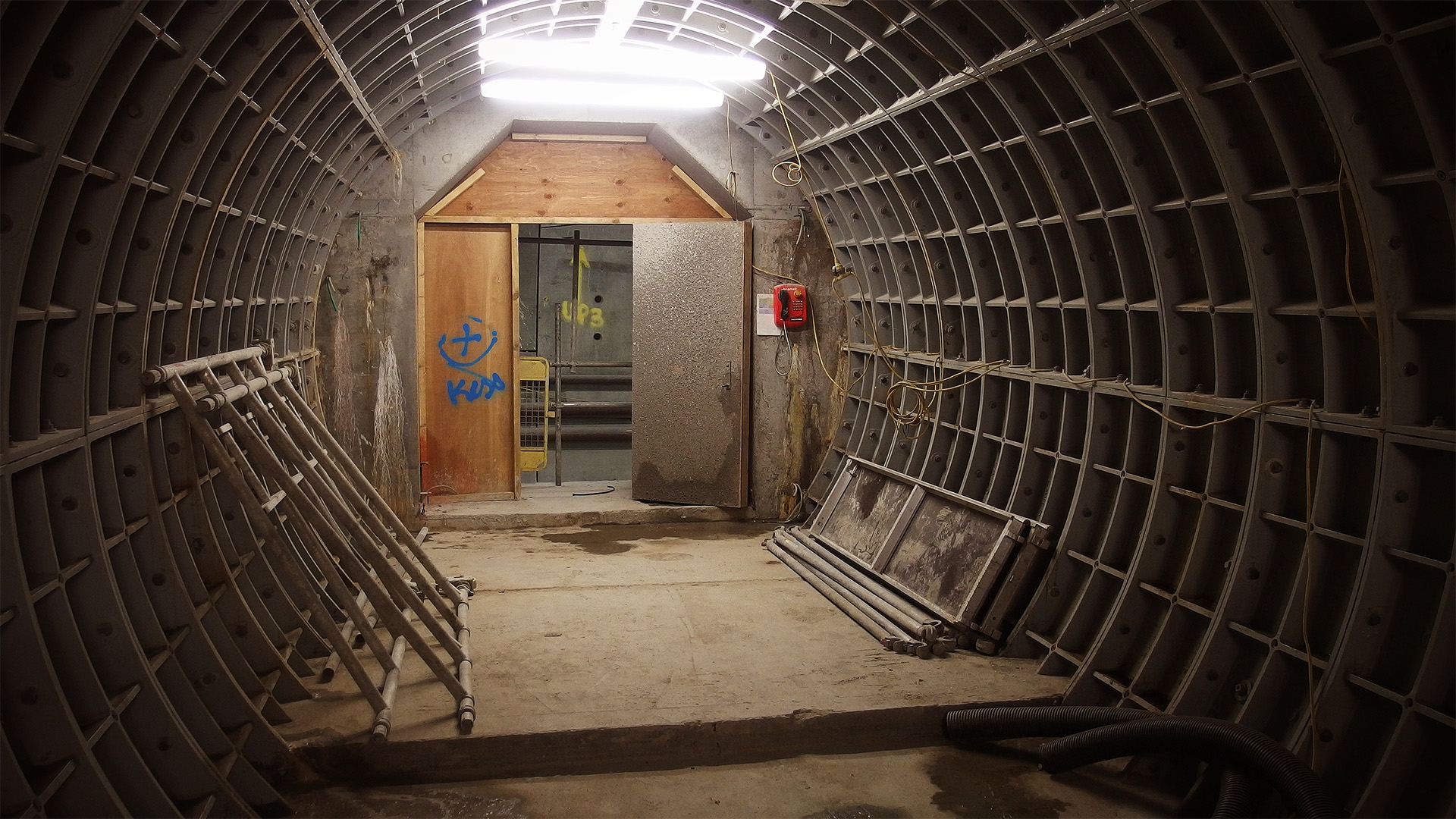 A narrow tunnel lined with curved steel plates
