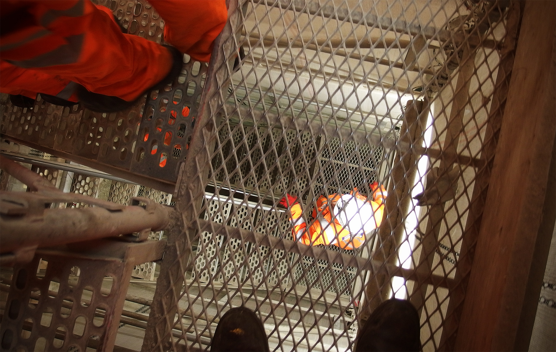 A view down through several flights of scaffolding staircases